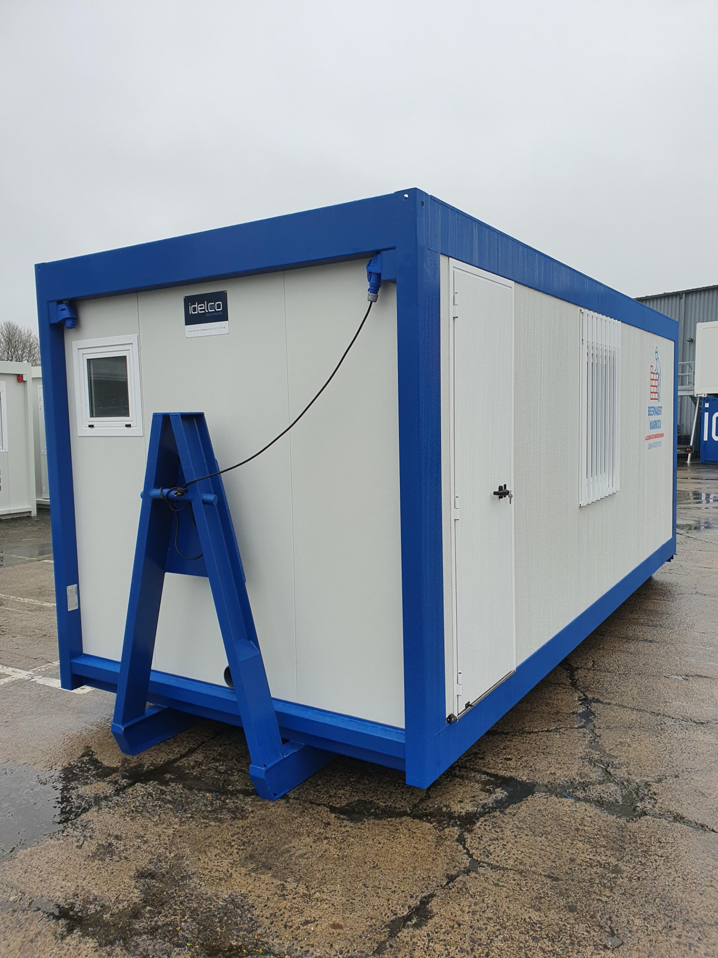 Construction worker inspecting a mobile modular unit manufactured by Idelco