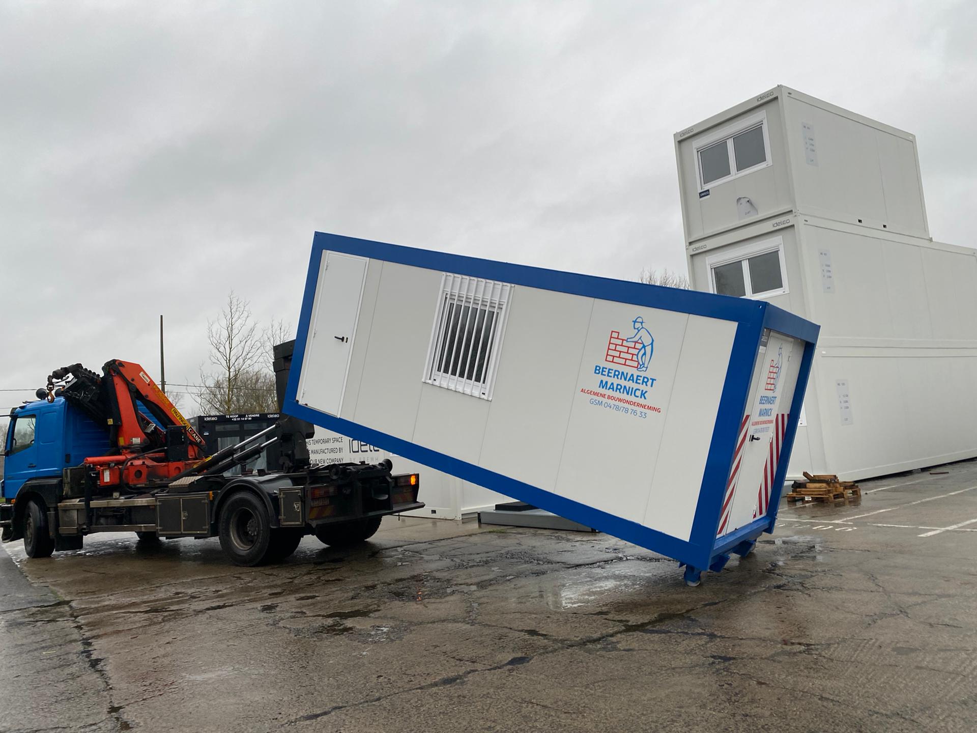 Close-up of the hooklift system and wheels on an Idelco site office container