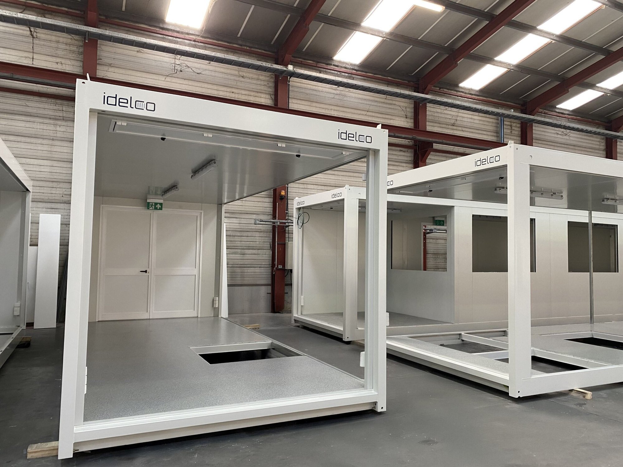 A set of modular office and canteen units by Idelco NV installed on a project site in Wallonia.